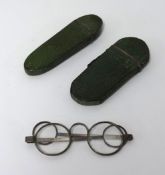 Two 19th century shagreen spectacle cases, one with a pair of steel spectacles