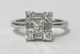 An 18ct white gold diamond ring, of square form set with an arrangement of round and baguette cut