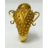 An 18ct yellow gold ring, in the form of a Greek urn, stamped ‘ZB17’, approx 6.40gms.