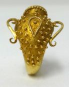 An 18ct yellow gold ring, in the form of a Greek urn, stamped ‘ZB17’, approx 6.40gms.