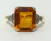 An 18ct citrine and diamond set ring, the citrine approx 10mm wide, finger size J1/2.