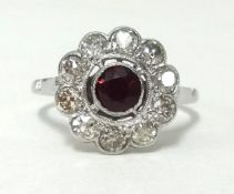 An antique platinum, ruby and diamond cluster ring, finger size M1/2, approx 9.70gms.