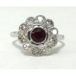 An antique platinum, ruby and diamond cluster ring, finger size M1/2, approx 9.70gms.