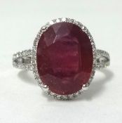 A 14ct white gold and diamond ring set with an oval cut ruby approx 5.30cts, diamonds approx 0.40cts