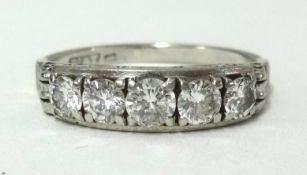 A platinum and diamond half band ring set with 5 diamonds, finger size N1/2.