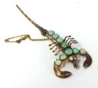 An unmarked gold brooch formed as a scorpion set with opals and diamonds.
