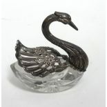 An Sterling silver swan with crystal glass base
