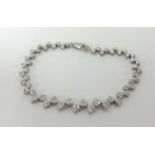 A fine 18ct white gold and diamond heart bracelet.