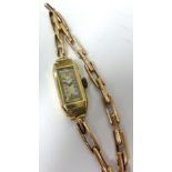 J.W. Benson, a 9ct gold ladies rectangular cased wristwatch.