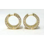 A pair of 18ct carat yellow gold creole hoop earrings, stamped .750, each with a channel set ow of