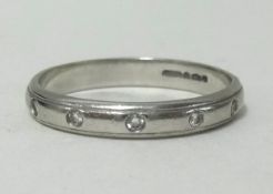A platinum and diamond set wedding band, finger size L, approx weight 3.3gms