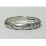 A platinum and diamond set wedding band, finger size L, approx weight 3.3gms