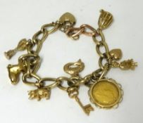 A gold charm bracelet including a Victoria half sovereign, total weight 44.50gms.