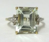 A 9ct gold large light green amethyst and diamond ring, finger size N.