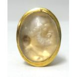 An Intaglio ring, a Greek portrait carved into a hardstone set in yellow gold, length 27mm, approx
