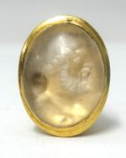 An Intaglio ring, a Greek portrait carved into a hardstone set in yellow gold, length 27mm, approx