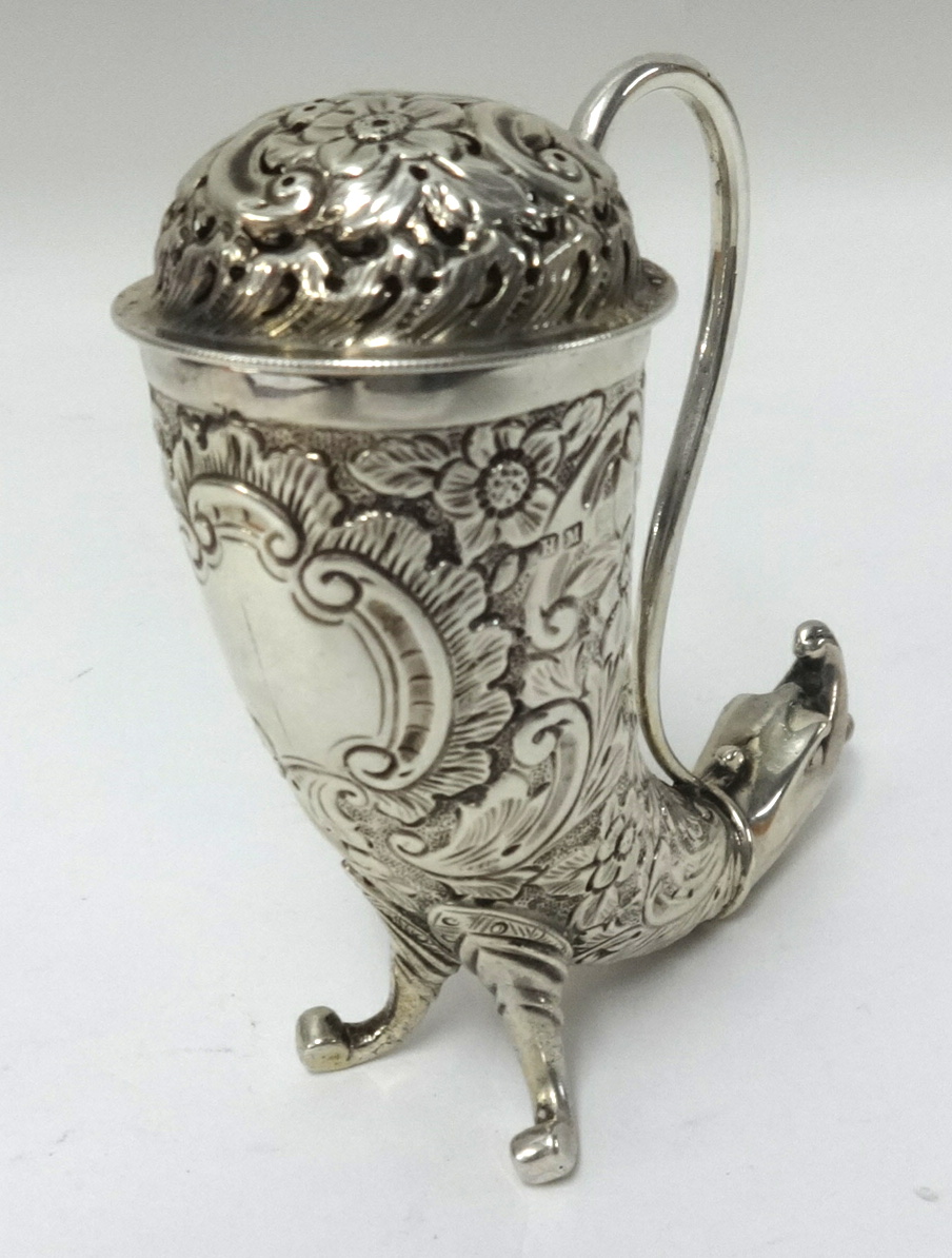 A Victorian silver pierced and chased sugar castor in the shape of a viking horn having a loop