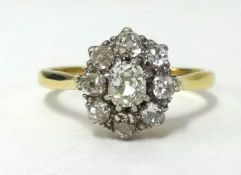 An 18ct diamond cluster ring, set with 9 old cut diamonds, the centre stone approx .50 cts, finger