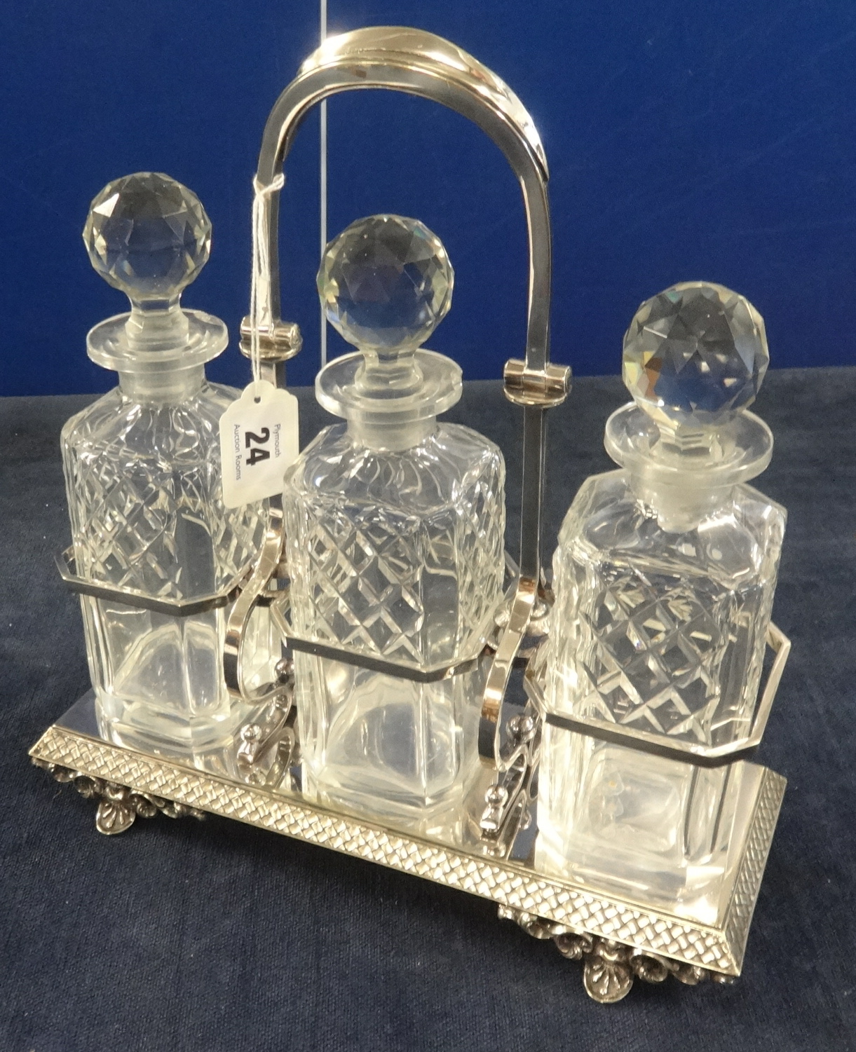 A silver plated 3 bottle Tantalus.