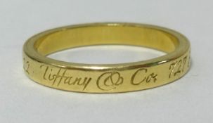 Tiffany, an 18ct yellow gold band ring with box and papers, purchased 2010, approx 3.60gms