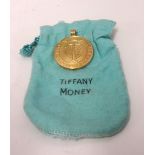 Tiffany Money, an 18ct gold pendant, 1000 Dollar, stamped 18k T, approx 33.70gms.