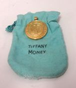 Tiffany Money, an 18ct gold pendant, 1000 Dollar, stamped 18k T, approx 33.70gms.