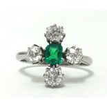 A platinum, emerald and diamond five stone ring, finger size M.