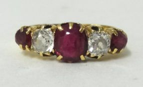 An antique yellow gold ruby and diamond set five stone ring, (no hallmark) finger size Q 1/2.