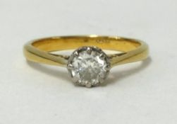 An 18ct gold diamond solitaire ring, set with an old cut stone.