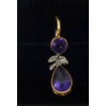 An amethyst and gold single pendant.