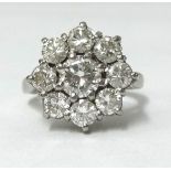 An 18ct white gold diamond cluster ring, having a round brilliant cut centre stone approx 0.70ct,