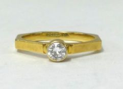 A 18ct gold diamond solitaire ring, the stone is 25 points set in octagonal shank 2mm wide, designer