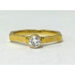 A 18ct gold diamond solitaire ring, the stone is 25 points set in octagonal shank 2mm wide, designer