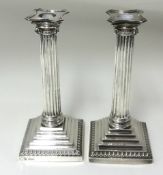 A pair of silver candlesticks, Corinthian column on stepped bases height 24cm.