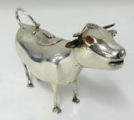 A late Victorian silver creamer in the form of a cow believed to be Dutch with English hallmarks,