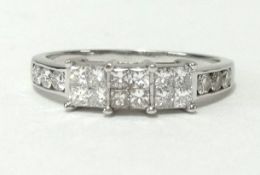 A platinum ring set with 18 princess cut diamonds, finger size R.