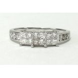 A platinum ring set with 18 princess cut diamonds, finger size R.