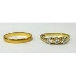 A three stone diamond ring stamped 750, approx 2.4gms together with a gold wedding band stamped 750,