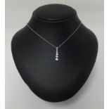 Tiffany, a diamond pendant, comprising six fine graduated diamonds, set in platinum , on a fine