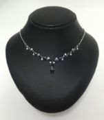 An 18ct white gold, diamond and sapphire set necklace.