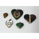 Four heart shaped pendants and one hard stone pendant.