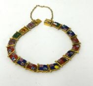 A gold bracelet (possibly 18ct) set with enamelled Flags of The British Empire, approx 17.20gms.