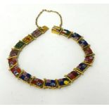 A gold bracelet (possibly 18ct) set with enamelled Flags of The British Empire, approx 17.20gms.