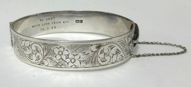 A silver bangle.