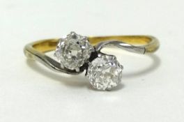 An 18ct diamond crossover ring, set with two old cut diamonds, weighing approx .50 carats in