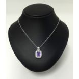 Mouawad, a fine 18ct white gold pendant, set with an emerald cut amethyst within a border of
