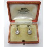 A pair of fine diamond cluster earrings each set with 9 stones in white metal settings with yellow