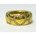 La Moda, an 18ct yellow gold band inset with diamonds in the form of hearts, stamped .750, approx