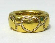 La Moda, an 18ct yellow gold band inset with diamonds in the form of hearts, stamped .750, approx