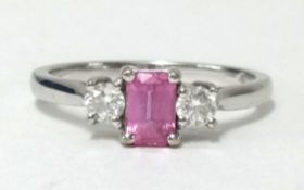 An 18ct white gold, pink sapphire and diamond three stone ring, finger size R1/2.